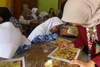 Mahasiswa KKN PPM UNISRI Kelompok 97 membimbing siswa kelas V SD Negeri 1 Sorogaten, Klaten, dalam praktik eksperimen pewarnaan motif batik menggunakan larutan asam dan basa sebagai bagian dari pembelajaran P5 bertema Kearifan Lokal. Foto: pribadi