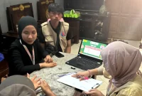 Mahasiswa KKN UNS Desa Ngumpul saat melakukan pendampingan langsung kepada pelaku UMKM terkait pencatatan keuangan sederhana dan strategi pemasaran produk di rumah warga. (doc. KKN 225 UNS)