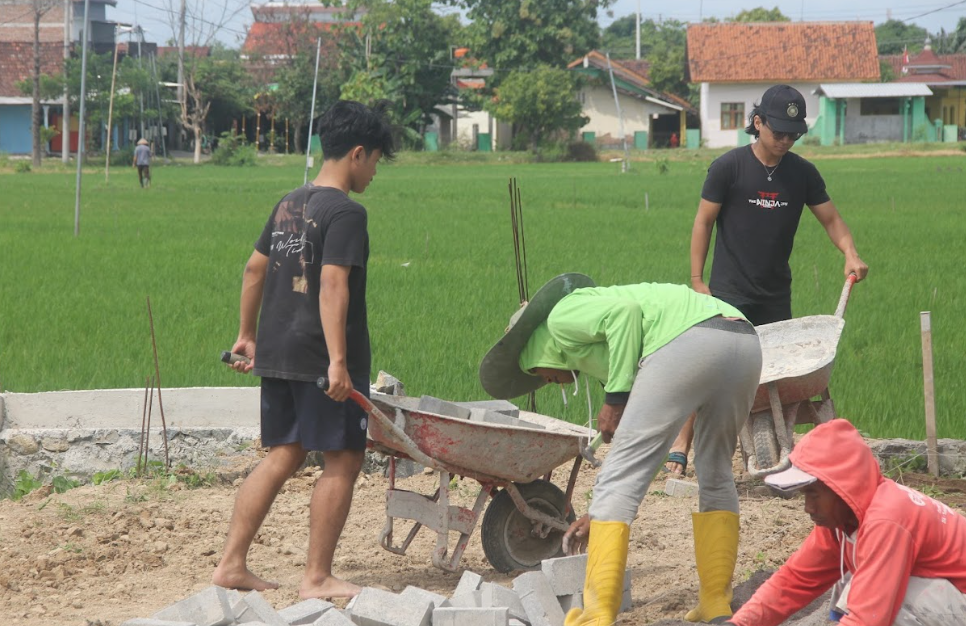 Dokumentasi kegiatan gotong royong membangun lapangan voli dan aula. Foto: Media HMS Project 2025