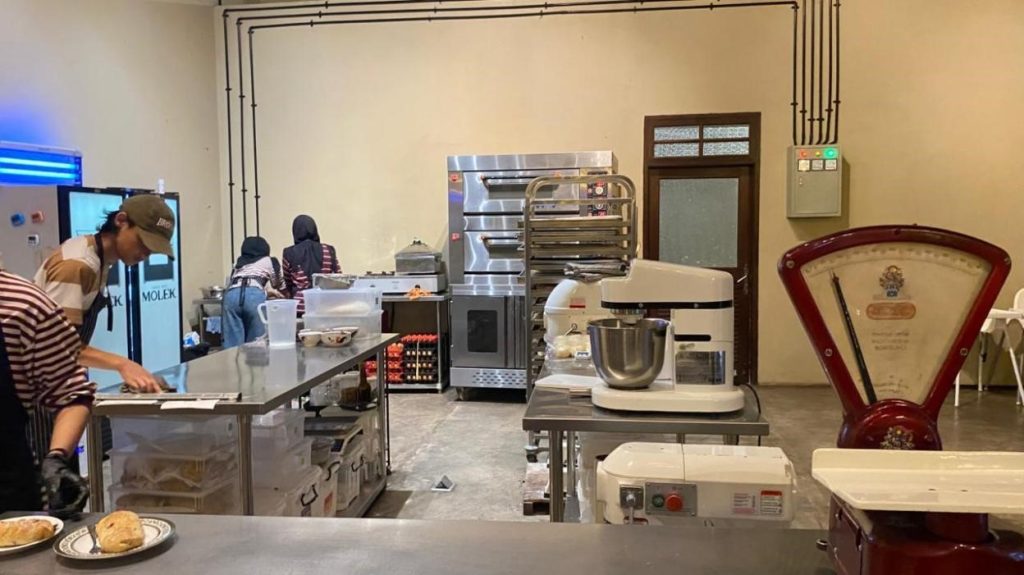 Para pekerja dapur tampak menyiapkan adonan dan memanggang roti di area produksi pastry.  Foto: Pribadi/Aprilia Setiani