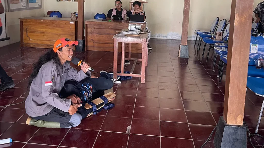 Narasumber dari EXALOS INDONESIA dan KATANYAPALA memperagakan teknik penanganan ular secara aman sebagai edukasi keselamatan bagi masyarakat di hadapan warga dan mahasiswa KKN UNS Kelompok 29 di Pendopo Kalurahan Grogol, Selasa (27/1/2026). Foto: Dokumentasi KKN UNS Kelompok 29 Grogol