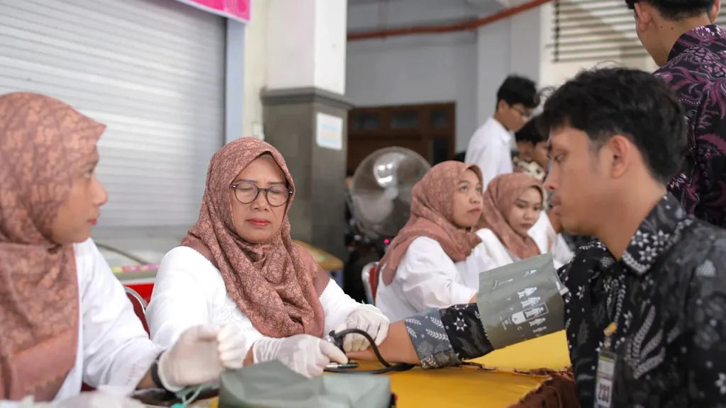 Petugas kesehatan memberikan layanan pemeriksaan tekanan darah kepada warga dalam kegiatan Safari Ramadan Pemkab Nganjuk di Pondok Pesantren Al Ubaidah, Kertosono. Foto: Pribadi