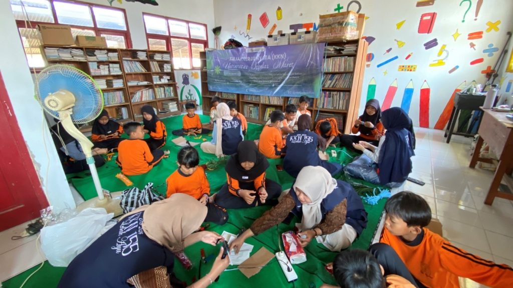Siswa SDN Lebak membuat kerajinan menggunakan kawat bulu dengan pendampingan mahasiswa KKN 155 UNS. (Dok. Pribadi/KKN 155 UNS, 2026)